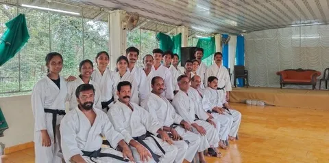 Senior instructors of Kassis Karate Academy India in white uniforms after the training camp at Kuttampuzha