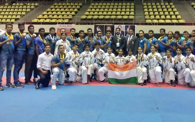 Karateka and officials posing with the Indian flag after the Indo-Sri Lankan match